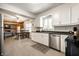 Modern kitchen with white cabinets, stainless steel appliances, and dark countertops at 6938 Rio Grande Dr, Indianapolis, IN 46217