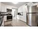 Kitchen with stainless steel appliances, white cabinets, and sleek countertops at 6938 Rio Grande Dr, Indianapolis, IN 46217