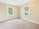 Bedroom with neutral walls, carpet flooring, and two windows providing natural light at 717 E 27Th St, Anderson, IN 46016
