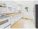Functional kitchen with white cabinets, laminate countertops, and lots of natural light at 717 E 27Th St, Anderson, IN 46016
