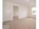 Bright bedroom featuring neutral carpet, white walls, and ample natural light from a large window at 7509 Big Bend Blvd, Camby, IN 46113