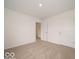 Bright bedroom featuring neutral carpet, white walls, and ample natural light with doorways at 7509 Big Bend Blvd, Camby, IN 46113