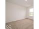 Bright bedroom featuring neutral carpet, white walls, and ample natural light from a large window at 7509 Big Bend Blvd, Camby, IN 46113