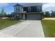 New two-story home with a concrete driveway and two car attached garage and newly landscaped lawn at 7509 Big Bend Blvd, Camby, IN 46113