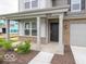 Inviting front porch with classic columns and stone accents on a two-story home at 7509 Big Bend Blvd, Camby, IN 46113
