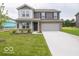Charming two-story home with a well-manicured lawn and attached two-car garage at 7509 Big Bend Blvd, Camby, IN 46113
