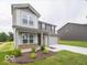 Two-story home featuring stone accents, attached two-car garage, and fresh landscaping at 7509 Big Bend Blvd, Camby, IN 46113