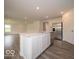 Open-concept kitchen with stainless steel appliances, white cabinetry, and a large center island at 7509 Big Bend Blvd, Camby, IN 46113