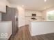 Contemporary kitchen features stainless appliances, white cabinets, and a large center island at 7509 Big Bend Blvd, Camby, IN 46113