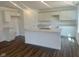 A modern kitchen featuring a kitchen island with sink, bright white cabinets, and wood floors at 7509 Big Bend Blvd, Camby, IN 46113