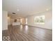 Open floor plan seamlessly connects the living area and kitchen, wood floors, and ample natural light at 7509 Big Bend Blvd, Camby, IN 46113