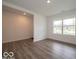 Open living room with sleek wood floors, neutral walls, and large windows offering natural light at 7509 Big Bend Blvd, Camby, IN 46113