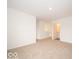 Upstairs hallway featuring neutral carpet and white walls, leading to additional rooms at 7509 Big Bend Blvd, Camby, IN 46113