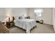 Cozy bedroom with neutral walls, carpet, and a window providing natural light at 7702 Justin Ln, Indianapolis, IN 46219