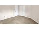 Bright, carpeted bedroom featuring neutral walls and closet storage at 7702 Justin Ln, Indianapolis, IN 46219