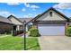 Charming home featuring a two-car garage, well-kept lawn, and lovely landscaping, perfect for suburban living at 7702 Justin Ln, Indianapolis, IN 46219