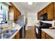 Functional kitchen with stainless steel appliances, warm wooden cabinets, and ample counter space for cooking at 7702 Justin Ln, Indianapolis, IN 46219