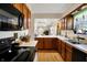 Spacious kitchen featuring ample counter space, wood cabinets, and a seamless transition to the living area, bright and open at 7702 Justin Ln, Indianapolis, IN 46219