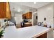 Open concept kitchen with modern appliances, a breakfast bar, and warm wood cabinetry for easy entertaining at 7702 Justin Ln, Indianapolis, IN 46219