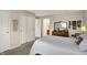 Serene main bedroom featuring carpet, a dresser with mirror, and closet storage at 7702 Justin Ln, Indianapolis, IN 46219