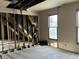 Bedroom view with exposed wall studs, missing drywall and insulation, and windows at 802 S Anderson St, Elwood, IN 46036