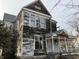 Exterior of a distressed two-story home with peeling paint and aged wood siding at 802 S Anderson St, Elwood, IN 46036
