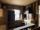 Kitchen with vintage wood cabinets ready for renovations or removal, and window at 802 S Anderson St, Elwood, IN 46036