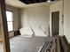 Empty living room with exposed walls and original wood floors; perfect for renovation at 802 S Anderson St, Elwood, IN 46036