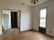 Living room view with hardwood floors, window, and open doorway leading to another room at 802 S Anderson St, Elwood, IN 46036