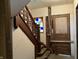 Stairway with decorative trim and a stained glass window; requires restoration at 802 S Anderson St, Elwood, IN 46036
