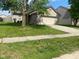 Well maintained brick house with green lawn and mature tree in the front yard at 8054 Painted Pony Dr, Indianapolis, IN 46217