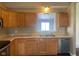 Galley kitchen with wood cabinets, laminate countertops and stainless steel appliances at 8054 Painted Pony Dr, Indianapolis, IN 46217
