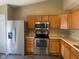 Functional kitchen with stainless steel appliances and wood cabinets offering plenty of storage at 8054 Painted Pony Dr, Indianapolis, IN 46217