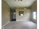 Open living room showcasing neutral walls, carpeted flooring, and a view of the front entrance at 8054 Painted Pony Dr, Indianapolis, IN 46217