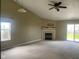 Bright and airy living room featuring a fireplace, ceiling fan, and sliding glass doors to the backyard at 8054 Painted Pony Dr, Indianapolis, IN 46217