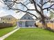 Spacious backyard with a lawn, patio seating, and mature trees at 809 N Temple Ave, Indianapolis, IN 46201