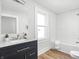 Bathroom featuring a tiled shower/tub, modern vanity with sink, and wood-look floors at 809 N Temple Ave, Indianapolis, IN 46201