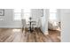 Bright dining area features hardwood floors, and is adjacent to a sitting area with a curved white chair at 809 N Temple Ave, Indianapolis, IN 46201