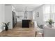 Open kitchen features a large island, stainless steel appliances, and an eat-in dining area with natural light at 809 N Temple Ave, Indianapolis, IN 46201