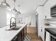 Modern, open kitchen features a large island with a sink, sleek white cabinets, and stainless steel appliances at 809 N Temple Ave, Indianapolis, IN 46201