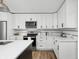Bright kitchen boasts white cabinetry, quartz countertops, stainless steel appliances and modern finishes at 809 N Temple Ave, Indianapolis, IN 46201