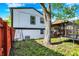 View of the backyard featuring a trampoline, deck, grassy area, and two-story home at 8103 Laughlin Dr, Indianapolis, IN 46219