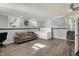 Finished basement features wood-look flooring, light grey walls, a comfortable couch, and ample space at 8103 Laughlin Dr, Indianapolis, IN 46219