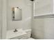 Neutral-toned half-bath features white vanity, sink, toilet, and block-wall construction at 8103 Laughlin Dr, Indianapolis, IN 46219