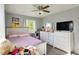 Comfortable bedroom with natural light, a ceiling fan and dresser at 8103 Laughlin Dr, Indianapolis, IN 46219