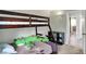 Comfortable bedroom with a wooden bunkbed, plush frog and a view of the adjoining bathroom at 8103 Laughlin Dr, Indianapolis, IN 46219