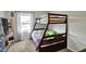Comfortable bedroom with a wooden bunkbed and a window at 8103 Laughlin Dr, Indianapolis, IN 46219