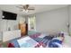 A bedroom with natural light includes dressers and a television at 8103 Laughlin Dr, Indianapolis, IN 46219