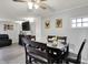 The open dining room offers ample seating with a ceiling fan and seamless flow into the living area at 8103 Laughlin Dr, Indianapolis, IN 46219