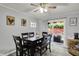 Bright dining room with a modern ceiling fan, sliding glass doors to the patio, and seating for six at 8103 Laughlin Dr, Indianapolis, IN 46219